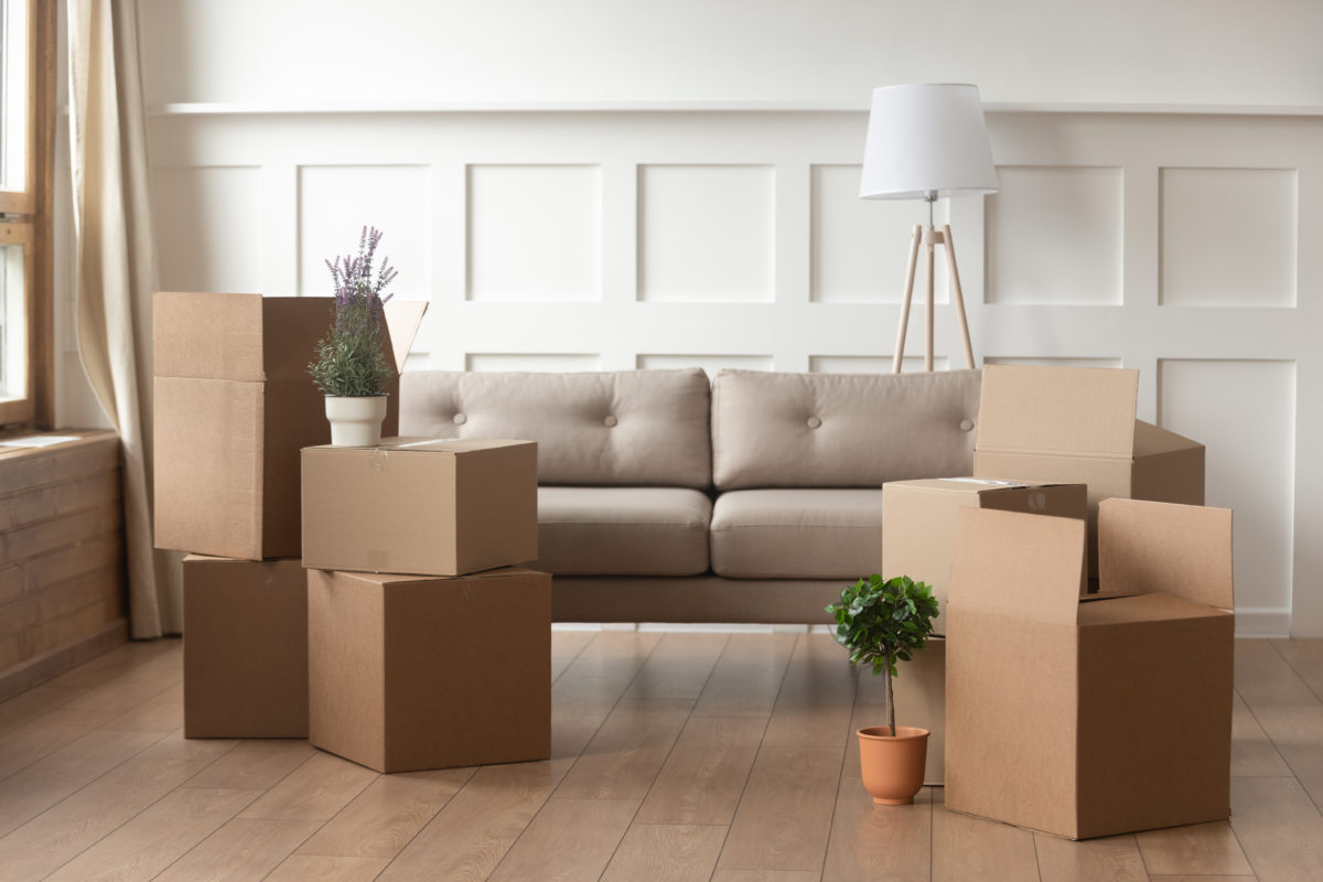 Moving day concept, cardboard boxes in modern house living room - Small Estate Affidavit